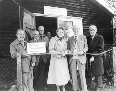 Jubilee Hall donation ceremony
Don Gresswell cuts the ribbon before handing the keys of Jubilee Hall to Enfield Preservation Society on 5th March 1986. 
Left to right: Albert Cotton, Wally Woodfield, Bob Errington, Mary Woodfield, Valerie Carter (EPS Chairman), Stanley Smith, Don Gresswell, Donald Potter (EPS President). 
Keywords: 1980s;Enfield Preservation Society;EPS;events;Jubilee Hall