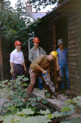 Working party outside Jubilee Hall
Stanley Smith prepares the ground for a disabled ramp at the side entrance, watched by (left to right) Wally Woodfield, Roger Dormer and Albert Cotton.
Keywords: Jubilee Hall;EPS;Enfield Preservation Society