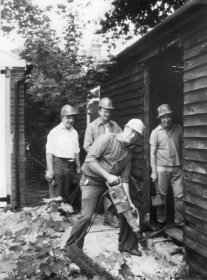 Conversion of Jubilee Hall
Enfield Preservation Society volunteers tackled nearly every job themselves in the conversion of Jubilee Hall. Here, Stanley Smith prepares the ground for a disabled ramp at the side entrance, watched by (left to right) Wally Woodfield, Roger Dormer and Albert Cotton.
Keywords: Jubilee Hall;Enfield Preservation Society;Parsonage Lane;1980s