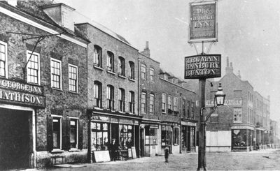 Enfield Town, south side, 1885
From left, shows the George Inn (later rebuilt in 1890), Meyer (printer, stationer and bookseller), Post Office, John Tuff (chemist), Henry Cave (grocer), Lock (draper).
Keywords: retail;inns;pubs;1880s;shops