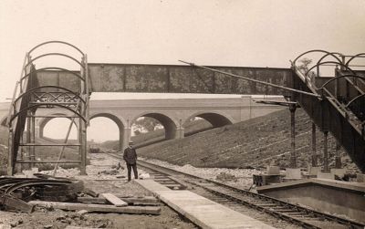 Gordon Hill station footbridge
A view of Gordon Hill station footbridge under construction in 1909 with, in the distance, the five span bridge carrying Lavender Hill across the line.
Keywords: railway stations;bridges;1900s