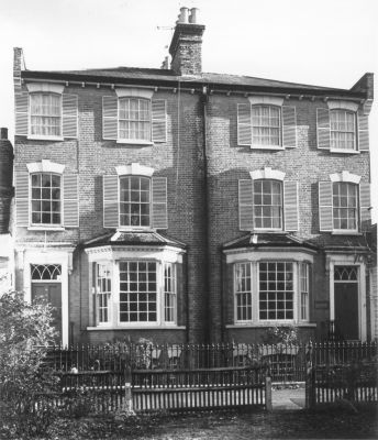 Fortescue Villas, 13 and 15 Gentleman's Row
Built in the 1840s on the site of an ancient large timber-framed house (probably c.15) called Fortescue Hall (demolished 1813), from which they derive their name, these two large houses have been divided horizontally into four spacious flats. At the turn of the last century they housed a school before becoming a children's home. Strong featured, with bracketed eaves and a slate roof set above sash windows with cambered heads, keystones and slatted external shutters. There are canted bays of brick at ground and basement level. The c.19 cast iron railings with ball and spike finials are also listed. - [i]Treasures of Enfield[/i]
Keywords: Gentlemans Row;residential houses;schools;Grade II listed