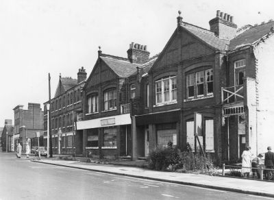 Palace Gardens houses
Before demolition these houses continued along the whole of the south side of the road to the right and were, at their best, quite desirable residences. They were built of red brick and had basement coal cellars. The coal was shot down through coal plates with a cover, and was just clear of the step to the front door. The Enfield Society has a cover which has been cleaned and treated. All the houses had outbuildings at the back.
