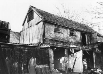 Laing's Garage: old barn and stables
The old house and stables at the end of the yard, which ran west to east. Note the dovecote at the west end, high up in the gable. At the time of demolition this building was reputed to be well over 300 years old. It was surveyed with the intention of taking it down and re-erecting it on another site, but it was found to be in too bad a condition. The survey found some rafters with original carpenters' marks, indicating re-used timbers of considerable age and quality. There was at one time a wooden stairway to the entrance at the first floor on the right.
Keywords: barns;stables