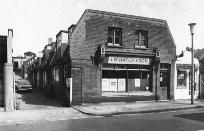 J. W. Hatch & Son, printers
The old family printing business of Hatch & Son at the corner of Palace Mews, which ran behind the Church Street shops. Behind Hatch was also the printing business of Pika Print who transferred to new premises in Genotin Road. Posters in the window advertise: 1. "Childrens ballet theatre"; 2. "Romeo and Juliet"; 3. "Open air arts and crafts exhibition"; 4. "Annual show".
