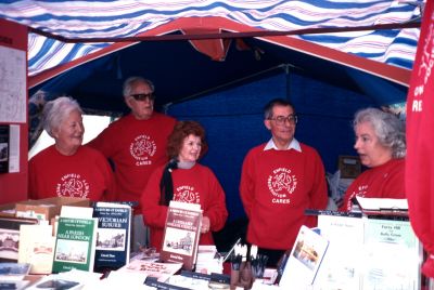 Five members of the Enfield Preservation Society staffing the stand at the Town Show, 1994
All are wearing EPS sweat shirts with the legend "Enfield Preservation Society CARES". The people shown are, from left to right, Brenda Soutar, an unidentified man wearing sunglasses, Dee Elwood, Colin Pointer and Irene Smith.
Keywords: Enfield Preservation Society;stalls;Town Show