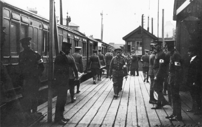 Wounded soldiers as stretcher cases being unloaded from train
The first of 139 wounded men arrived at Lower Edmonton low level station on Friday evening, 14th May 1915. A large crown waited there, flowering plants were brought from Barrowfield nurseries, someone produced a Union Jack and "Welcome to our heros" was chalked up on the wall. - [i]History of Enfield[/i], vol.3, p.25.
Photograph by Cyril Marsh Neaves (1877-1934), official photographer of the Middlesex Voluntary Aid Detachment (VAD), 1914-1918.
Keywords: soldiers;World War I;postcards;railway stations;rail transport