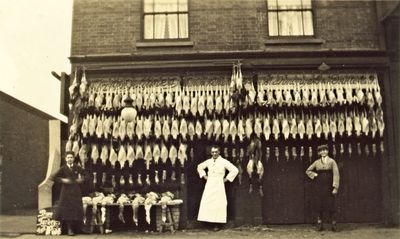 Clarke & Symes, fishmongerers and poulterers
Perhaps at their shop at 145 High Street, Waltham Cross. They traded there in 1939-1943, but this picture is from earlier that century, by comparison with other similar images. A. H. Clarke also traded at 109 Ordnance Road, Enfield.
Keywords: 1910s;butchers;shops;retail