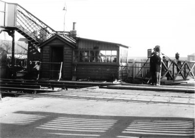 Railway level crossing, Duck Lees Lane, 1962
View looking east, early 1962. Of interest because the crossing gates were operated by a wheel in the crossing keeper's hut. The gates opened towards the road rather than across the railway, as is more usual. The crossing was closed in 1965 and there is now just a footbridge with long ramps at this location.
Keywords: rail transport;bridges;1960s;level crossings