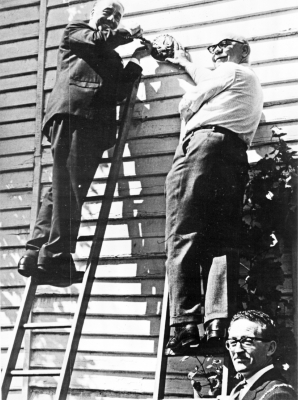 Listed building plaque being fixed to White Lodge
Enfield Preservation Society listed building plaque being fixed by Rupert Jarvis (secretary of the London and Middlesex Archaeological Society) and Tony Lane (chairman of the Enfield Preservation Society) in August 1966, while the Mayor holds the ladder. - [i]Fighting for the future[/i], page 48.
Keywords: 1960s;listed buildings;plaques;events;Enfield Preservation Society;publications;EP1