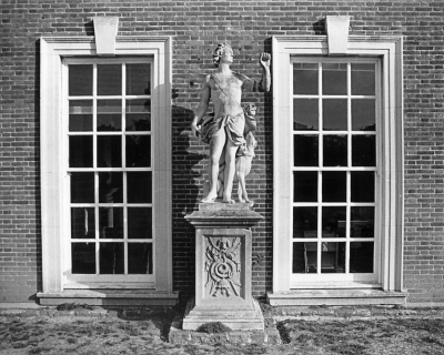 Statue of Actaeon, Trent Park
At left of front door of the mansion. Statue. Circa 1700; in 1934 brought to Trent Park from Wrest Park, Beds by Sir Philip Sassoon. Ashlar plinth; lead statue. Plinth, with moulded base and cornice, has front carved with hunting trophy. Statue depicts Actaeon with restored raised arm, and seated dog behind. Register of Parks and Gardens of special historic interest in England, Part 17, Greater London. Information from [url]http://list.english-heritage.org.uk/resultsingle.aspx?uid=1079459[/url]
Keywords: sculpture;statues;Grade II listed