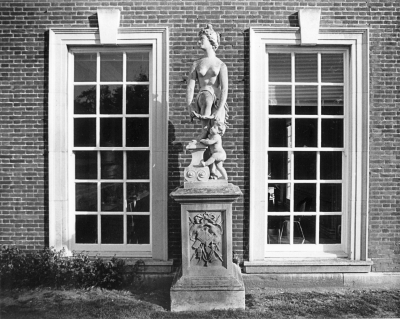 Statue of Venus, Trent Park House
Listed Grade II (group value). Statue. Circa 1700 with later head; in 1934 brought to Trent Park from Wrest Park, Beds, by Sir Philip Sassoon. Ashlar plinth, lead statue. Plinth, with moulded base and cornice, has front carved with weapons of the hunt, pair of birds and toiletry items. Statue depicts Venus tying garter of leg raised on pedestal with a cupid at her feet. - Description from [url]http://list.english-heritage.org.uk/resultsingle.aspx?uid=1260775[/url]
Keywords: sculpture;statues;Grade II listed