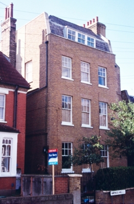 Glenwood House, Wades HIll
Circa 1800 house of 3 storeys, attic and basement, formerly one of a pair of which the right one is missing and the party wall rather clumsily rendered. Stock brick with plinth. Slated mansard roof with triple dormer. Gauged brick arches to replaced sash windows, the upper ones with glazing bars. 2-storey set back left entrance extension has 6-panel door in reeded architraves with patterned radial fanlight over. - [i]British Listed Buildings[/i]
Keywords: 1800s;Grade II listed;houses