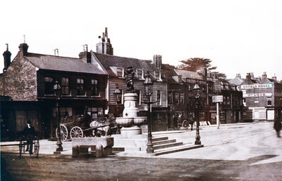 The Town, about 1908
The fountain in the foreground has four lampposts at the corners of its plinth. Horse-drawn vehicles in the rear, and a man on a high-wheel tricycle.
Keywords: 1900s;horse-drawn vehicles;fountains;tricycles