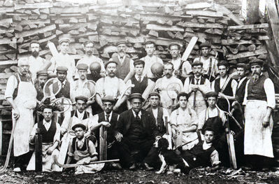 Staff of George Halsey's factory in Baker Street, c.1900
The factory made cricket bats, tennis rackets and hockey sticks, and was still in business in 1939. A large pile of cleft willows in various stages of seasoning is seen in the yard behind the workers. See [i]History of Enfield[/i] vol.2, p.142.
Keywords: 1900s;industry;factories;people;sports