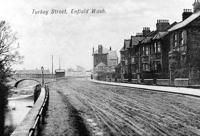 Turkey Street, Enfield Wash, 1911
Looking east towards Hertford Road. Bridge over the Turkey Brook on the left. Copy of a postcard.
Keywords: 1910s;roads and streets;bridges;rivers and streams;postcards;Bulls Cross