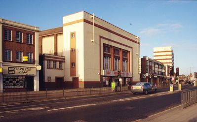 Savoy cinema, Southbury Road, April 1995
View from the east. A Cannon cinema.
Does anyone know what the rods fixed to the front of the building are for? They look like door handles! Were they perhaps for fixing a big banner across the front of the cinema?
Keywords: cinemas;1990s;demolished buildings