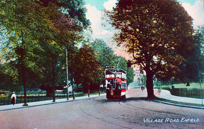 Tramcar in Village Road
A tramway along Village Road and Park Avenue was opened in 1909. This route was chosen because the trams could not manage the gradients on the old main road over Bush Hill.
Keywords: roads and streets;road transport;tramcars;postcards