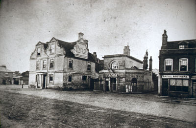 The Town, north side
Greyhound Inn, old policy station and Savill Brothers 

[i]Reproduction right held by Enfield Local Studies Library and Archive.[/i]
Keywords: pubs;19th century;shops