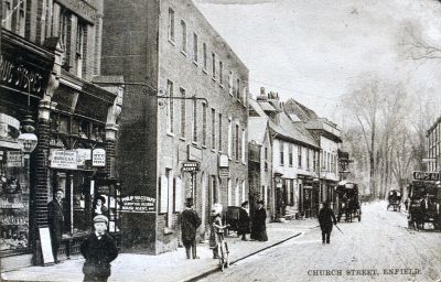 Church Street
Shows horse-drawn vehicles, a woman with a bicycle and a man with a top hat. Shop signs include "Drug store", "Philip Wagstaff, House Agent" and the "Rising Sun" public house.
Keywords: 19th century;pubs;shops;horse-drawn vehicles;bicycles